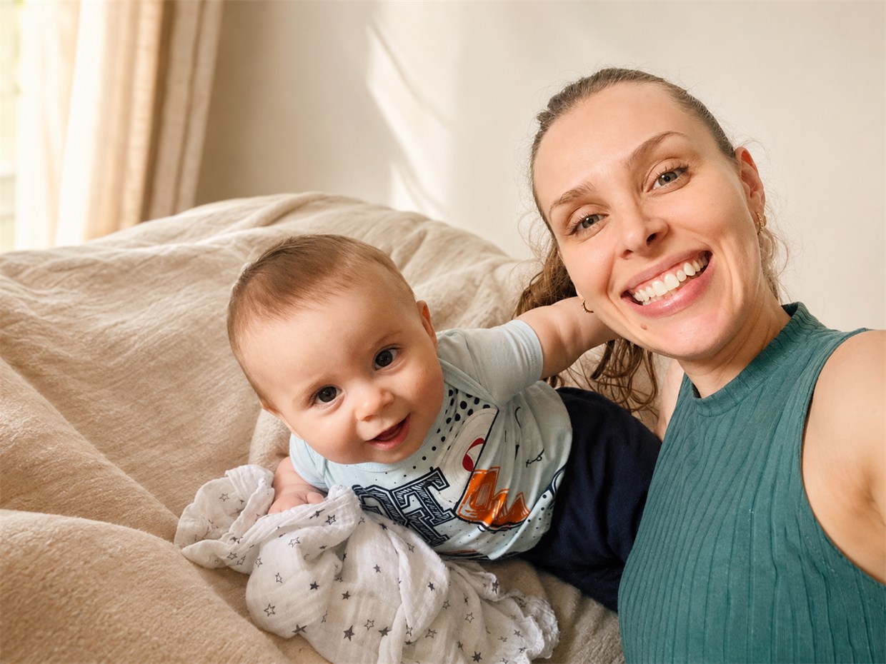 Luiza Knabben, criadora do Meu Enxoval Certo, sorrindo com o filho Estevão no colo